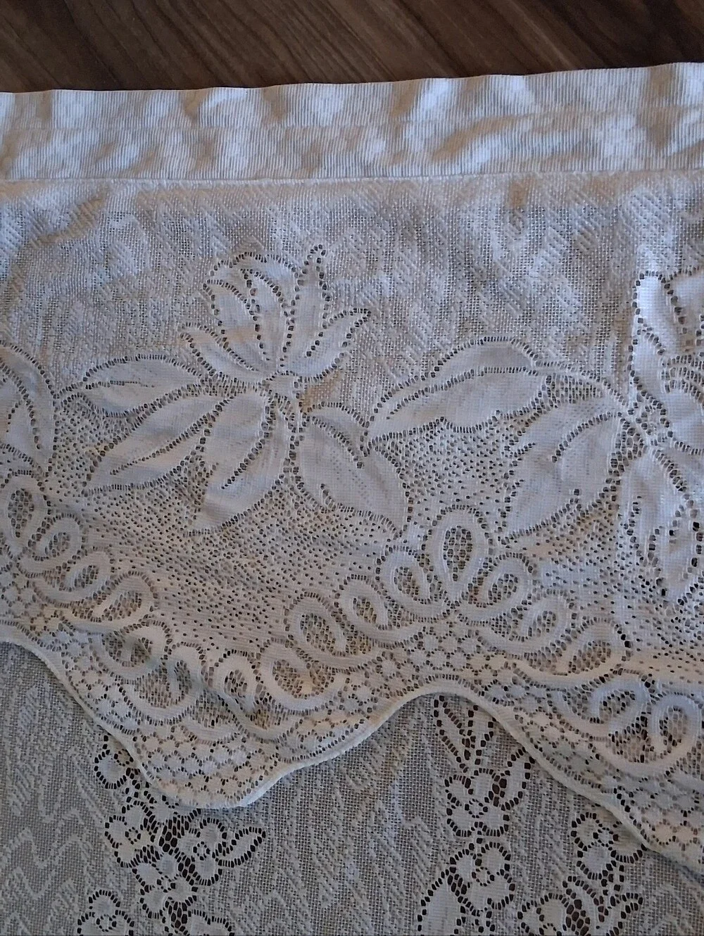 Vintage style floral lace curtain panel featuring an attached scalloped valance.